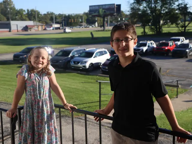 A girl and a boy smiling on the church front steps