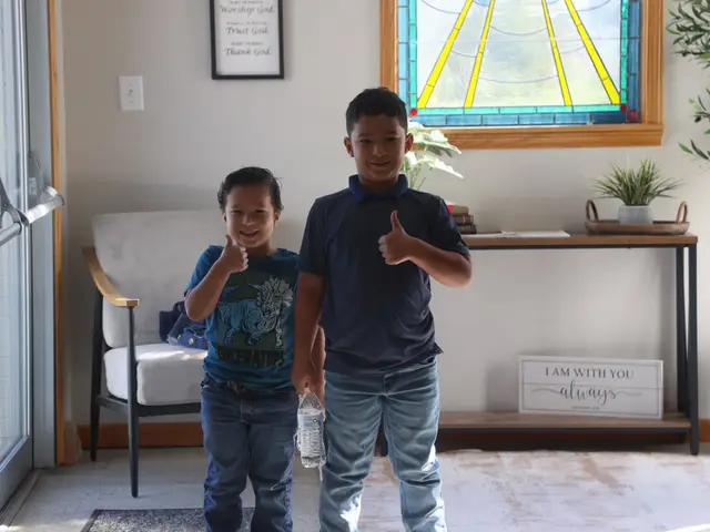 Two boys giving a thumbs up in the church entryway