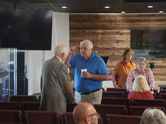 Church members talking over coffee in the sanctuary before the service
